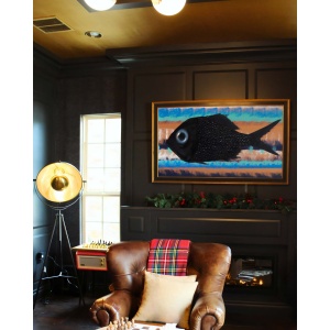 Nekol’s Fish #1 oil painting in a home interior: a textured black fish on abstract blue, orange, and white stripes, adding vibrant contrast.
