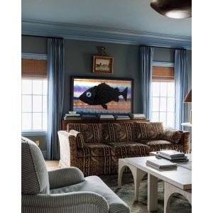 Nekol’s Fish #2 oil painting in a home interior: A single, surreal black fish floats across a vibrant, layered background of abstract, wave-like colors
