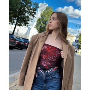 Woman wearing a vibrant Silk Satin scarf with cactus designs in bold colors by NEKOL