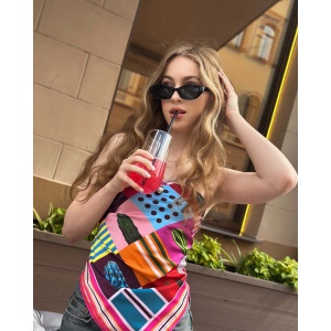 Woman wearing a vibrant Silk Satin scarf with cactus designs in bold colors by NEKOL