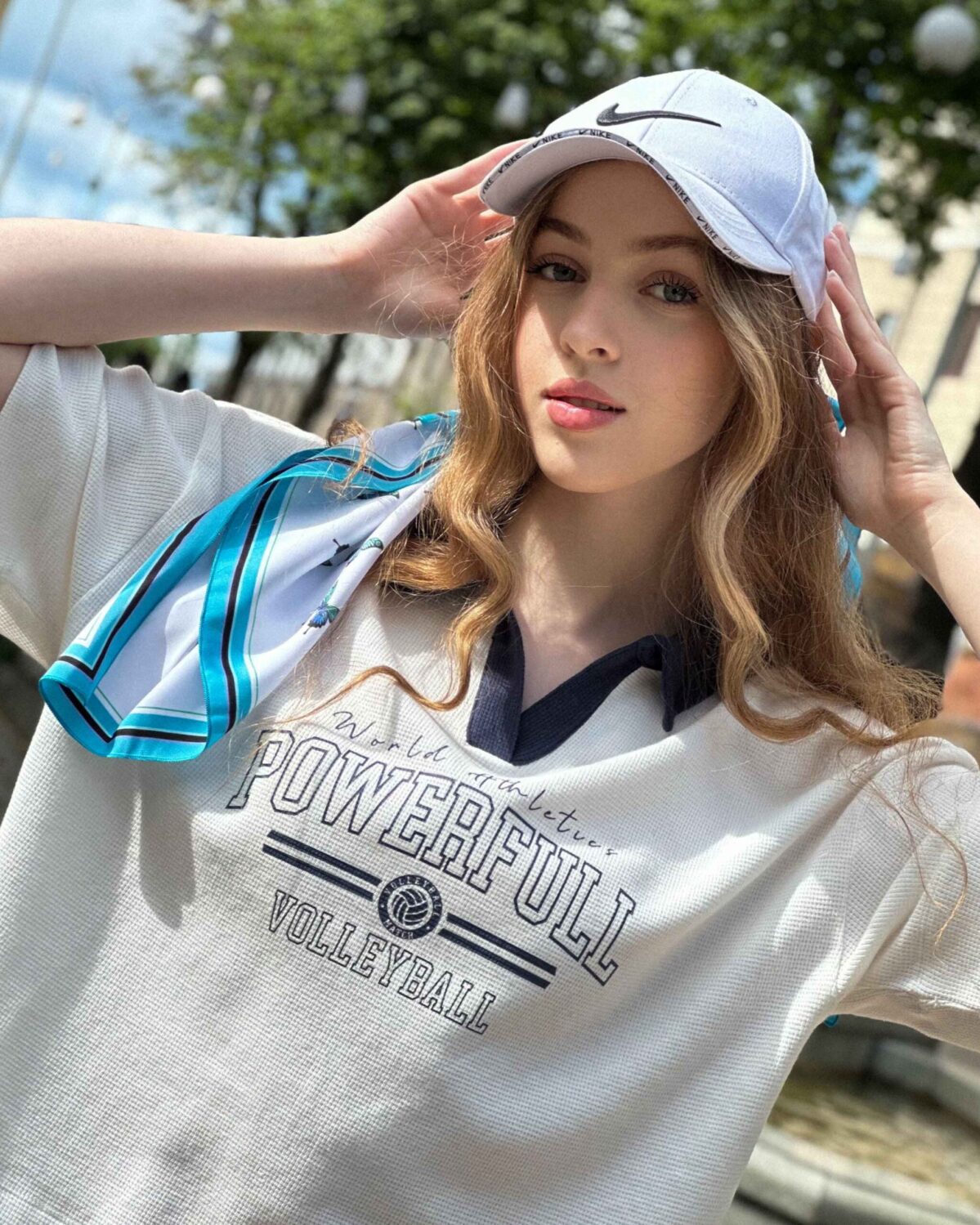 Blue butterfly silk scarf styled with casual outfit outdoors