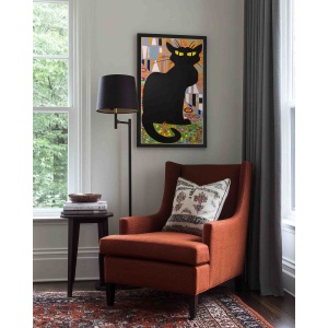 chat noir oil painting displayed in modern interior with armchair