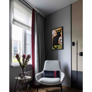 chat noir oil painting displayed in modern interior with armchair