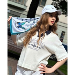 Blue butterfly silk scarf styled with casual outfit outdoors