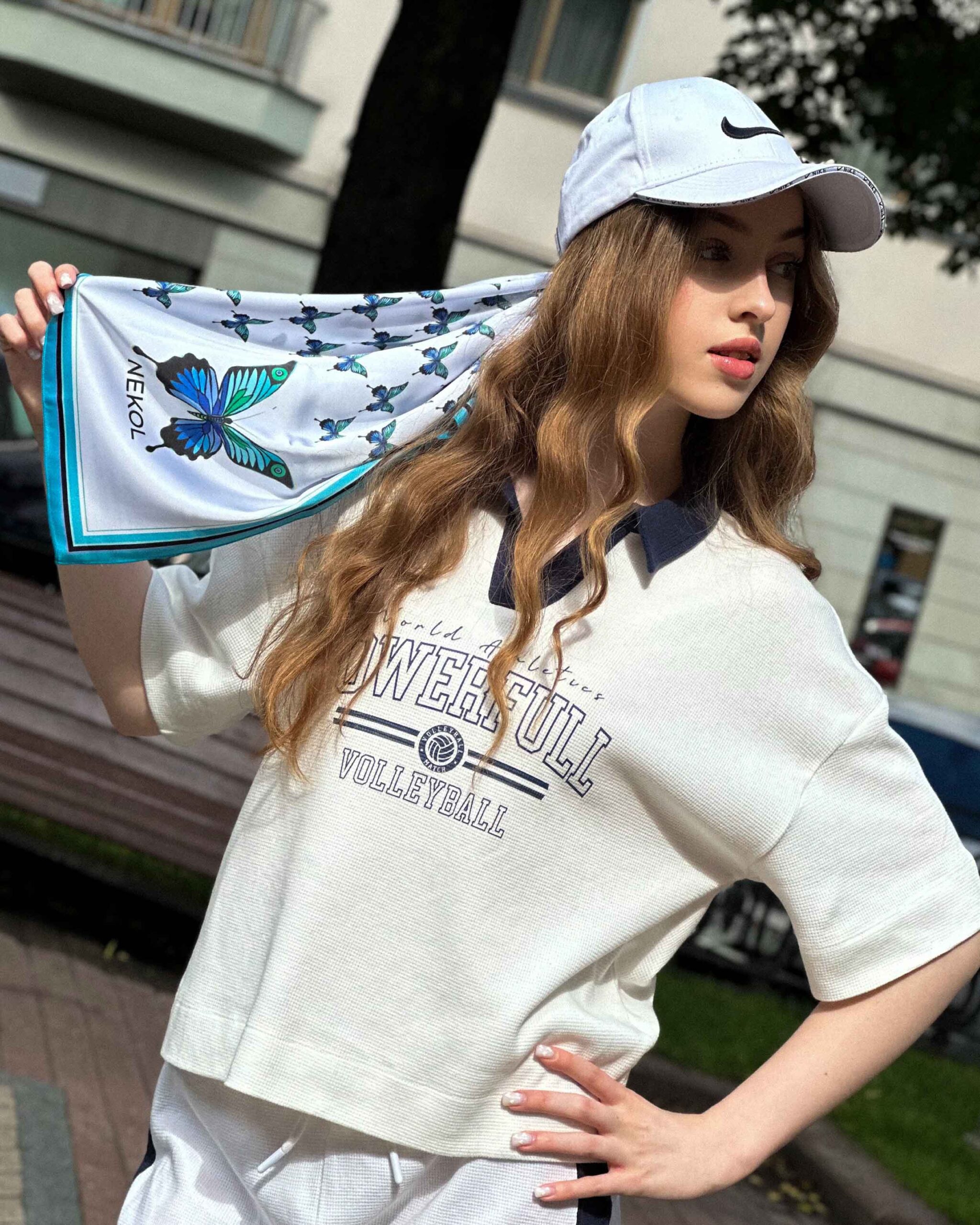 Blue butterfly silk scarf styled with casual outfit outdoors