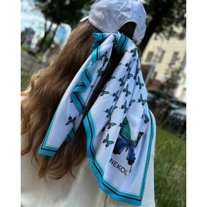 Blue butterfly silk scarf tied on hair in outdoor street style