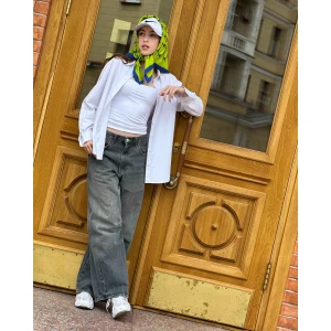 Blue butterfly silk scarf worn as a headscarf with vibrant lime and blue pattern.